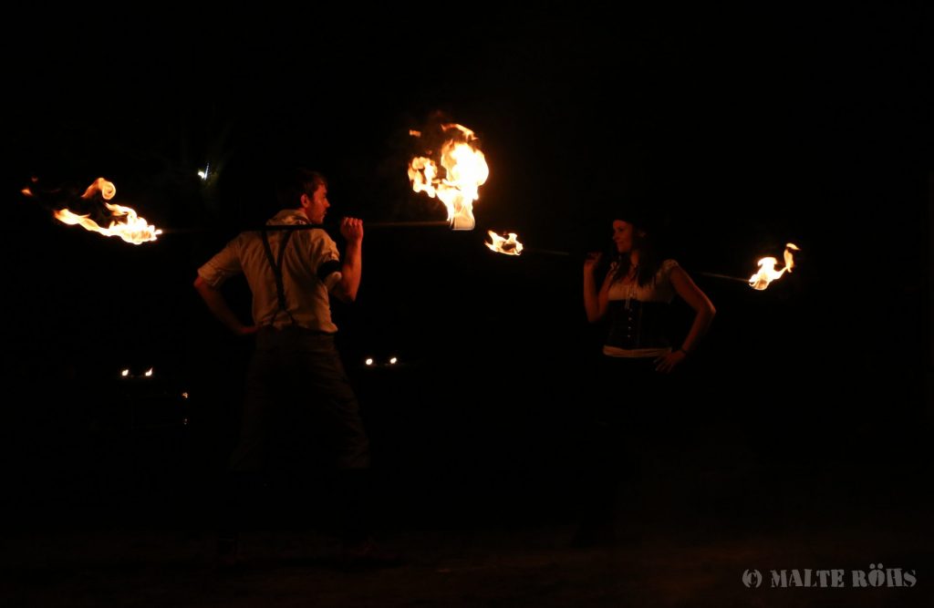 Sabine and Tim from Hot & Twisted during a performance with fire staffs
