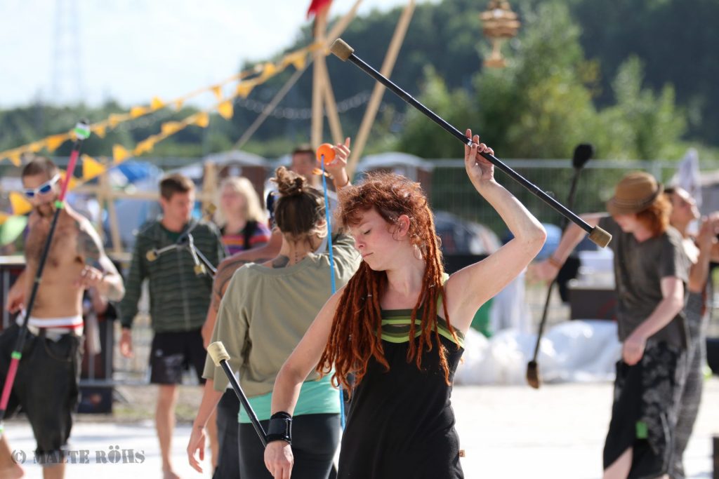Woman playing with two fire staffs during the European Juggling Convention (EJC) 2016 in Almere, Netherlands
