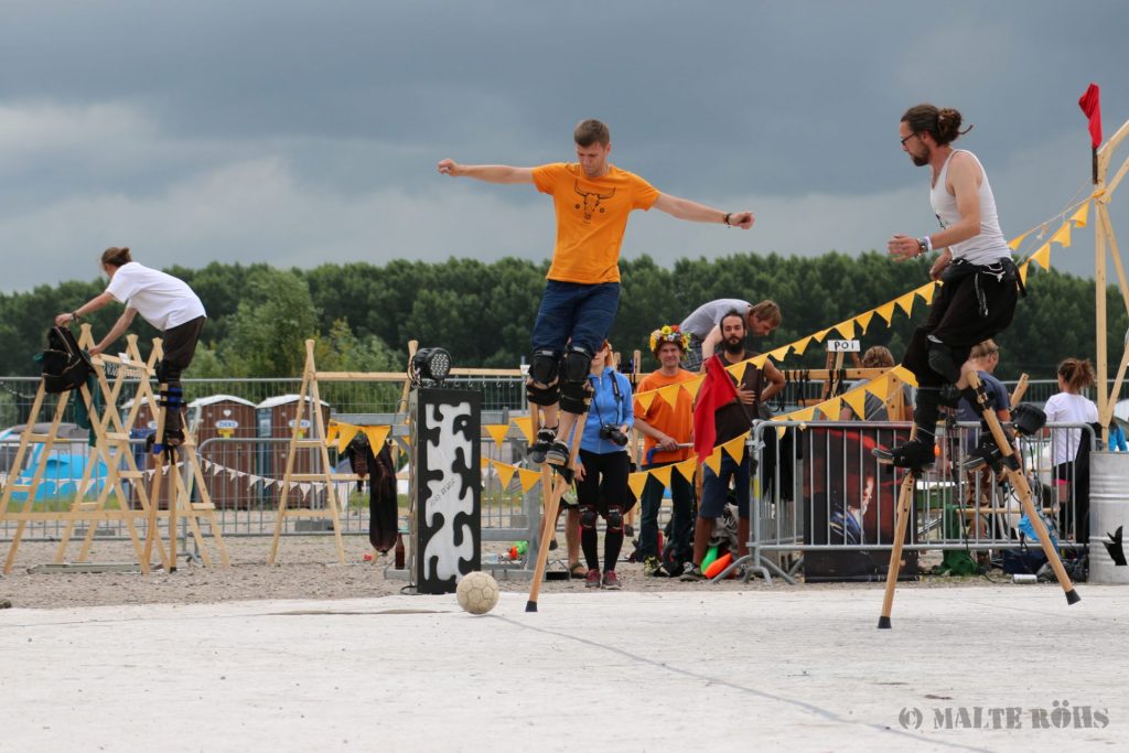 Stilt walkers playing football during the European Juggling Convention (EJC) 2016 in Almere, Netherlands