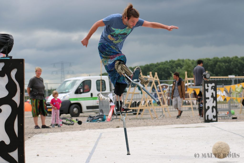 Stilt walker playing football during the European Juggling Convention (EJC) 2016 in Almere, Netherlands
