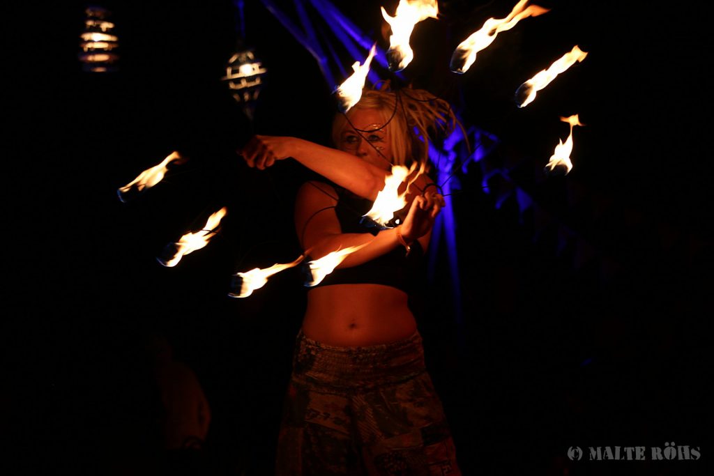 Fire performance with a fire fan on the fire space during the European Juggling Convention (EJC) 2016 in Almere, Netherlands
