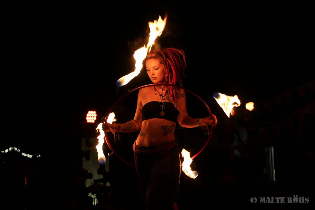 Fire performance with a hula hoop on the fire space during the European Juggling Convention (EJC) 2016 in Almere, Netherlands