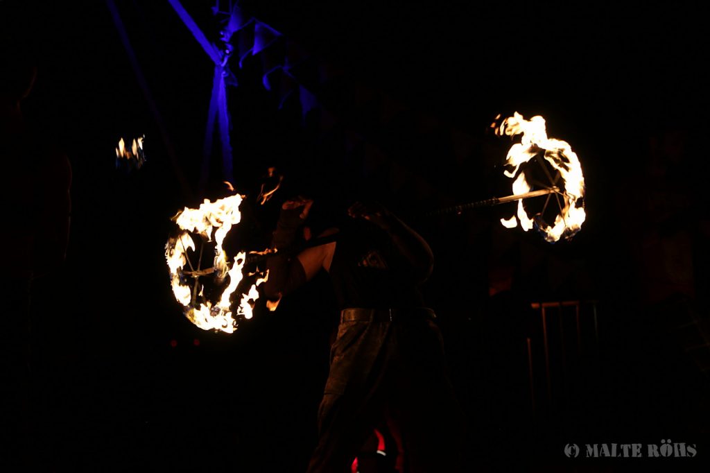 Fire performance with a dragon staff on the fire space during the European Juggling Convention (EJC) 2016 in Almere, Netherlands